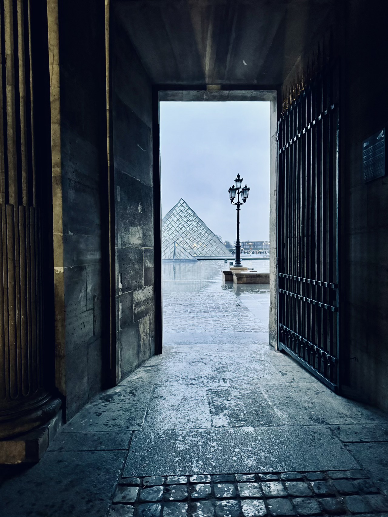 Louvre Pyramid through a walkway
